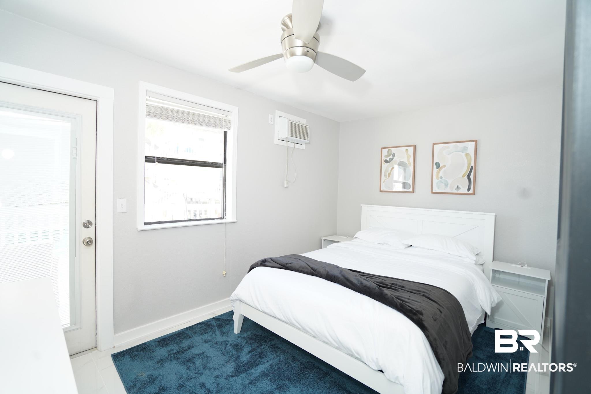 Image 3: Bedroom with a ceiling fan and baseboards