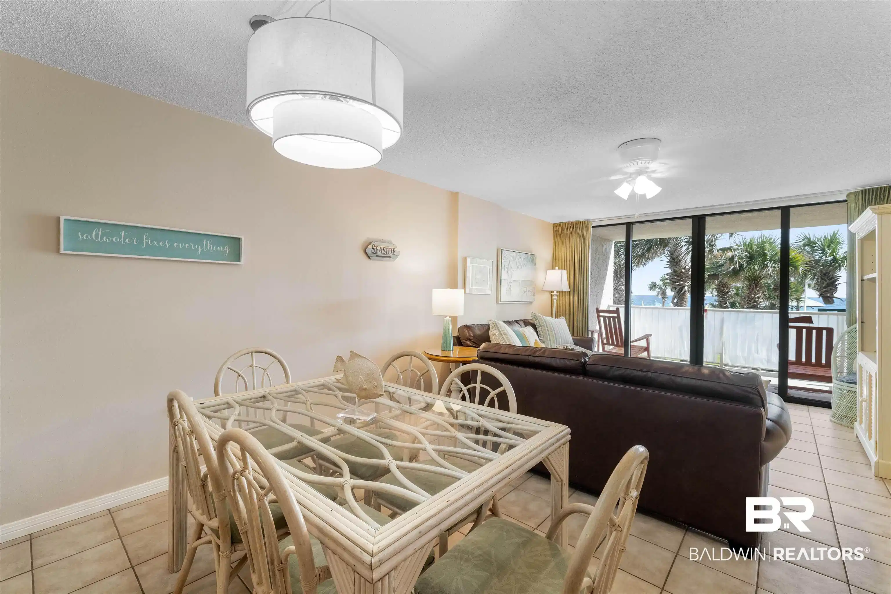 Image 1: Dining space featuring a textured ceiling, light tile patterned flooring, expansive windows, and ceiling fan