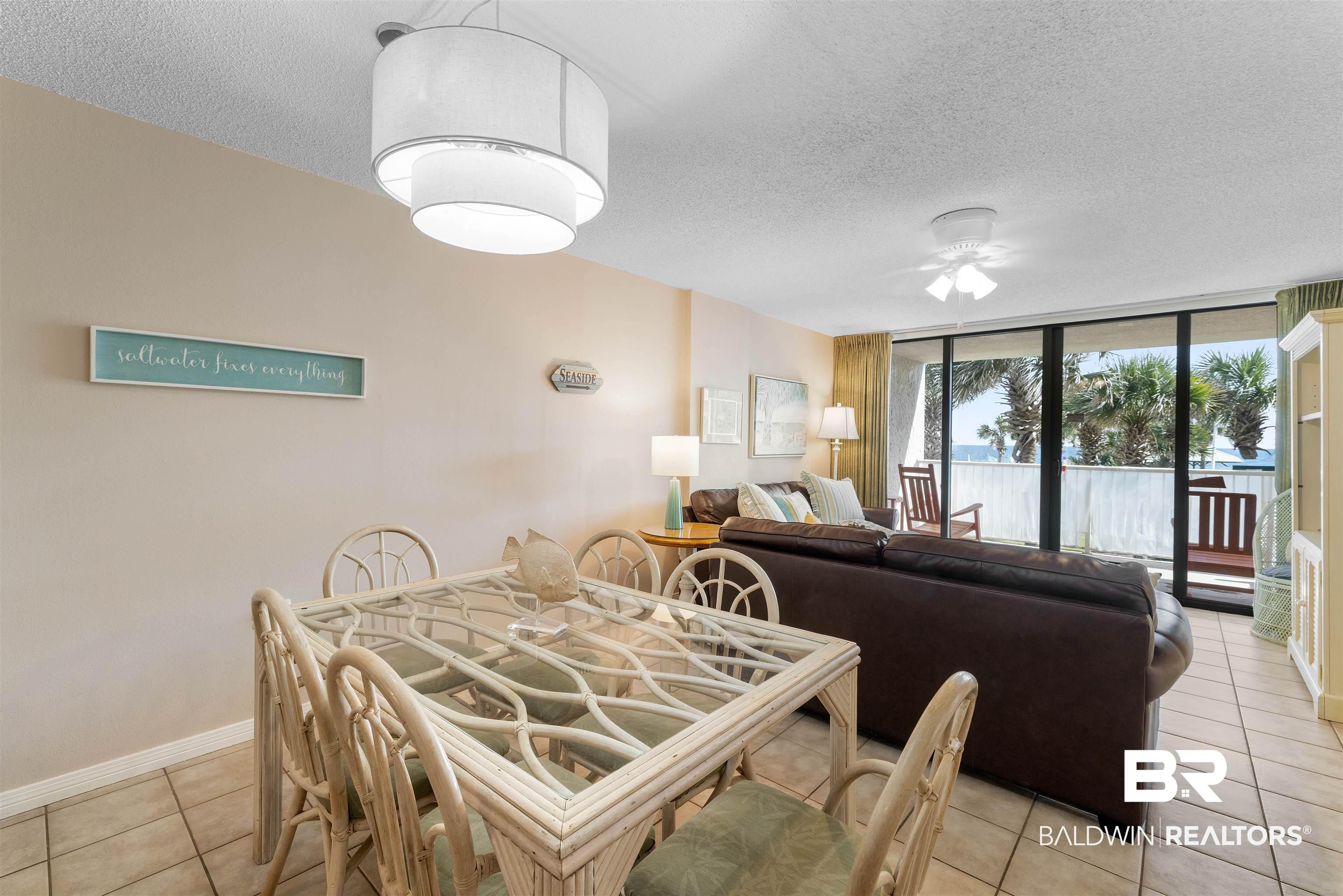 Image 2: Dining space featuring a textured ceiling, light tile patterned flooring, expansive windows, and ceiling fan