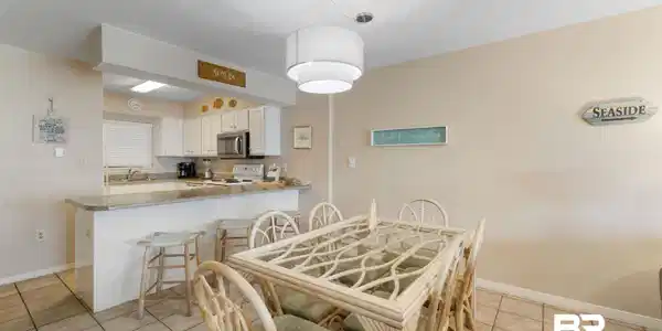 Image 3: Dining room with light tile patterned flooring and a textured ceiling