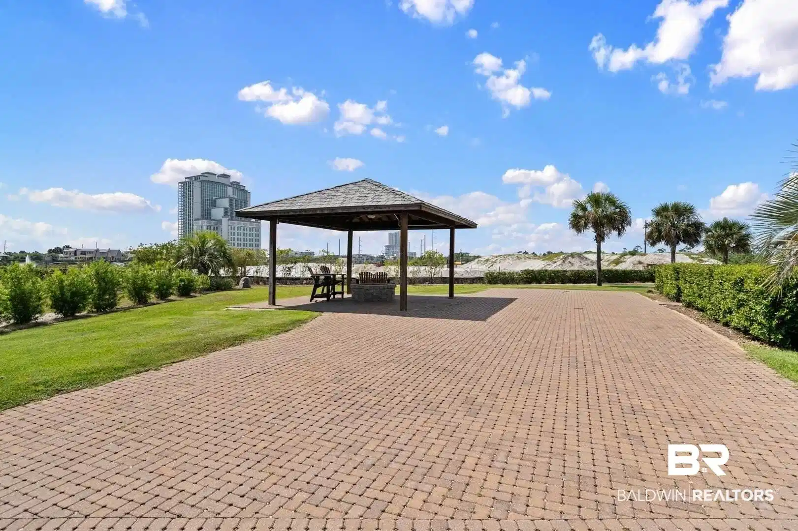Image 1: View of property's community featuring a patio and a yard