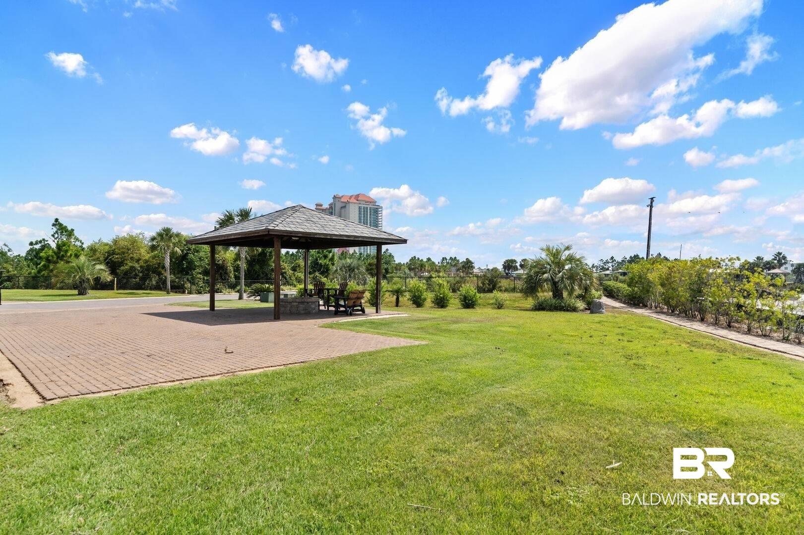 Image 2: View of home's community featuring a gazebo, a patio area, and a lawn