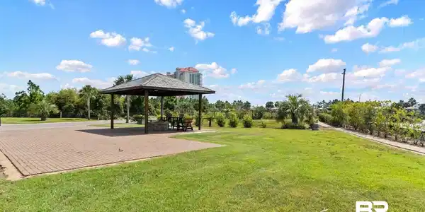 Image 2: View of home's community featuring a gazebo, a patio area, and a lawn