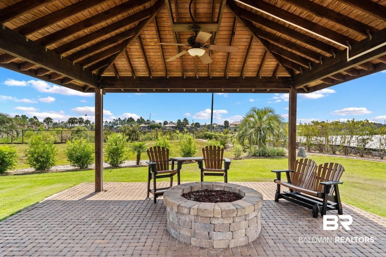 Image 4: View of patio / terrace with ceiling fan and a fire pit