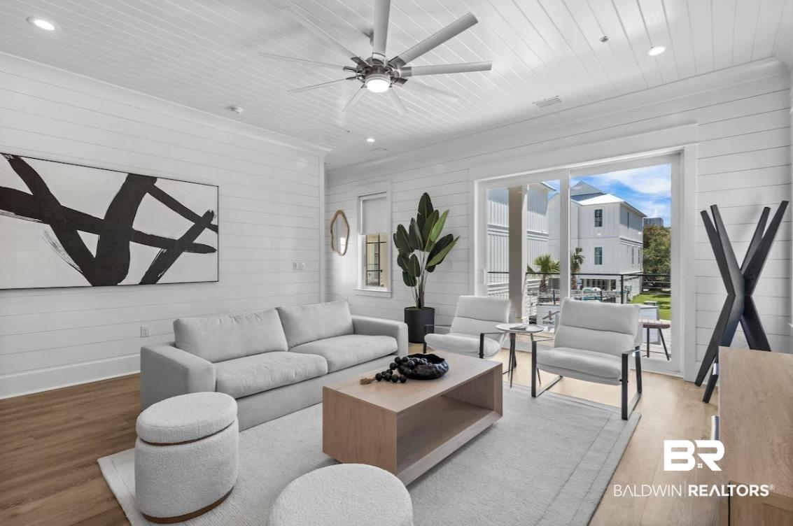 Image 4: Living room with wooden walls, wood finished floors, recessed lighting, ceiling fan, and wood ceiling