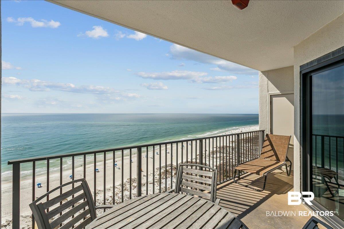 Image 3: Balcony featuring view of water and beach