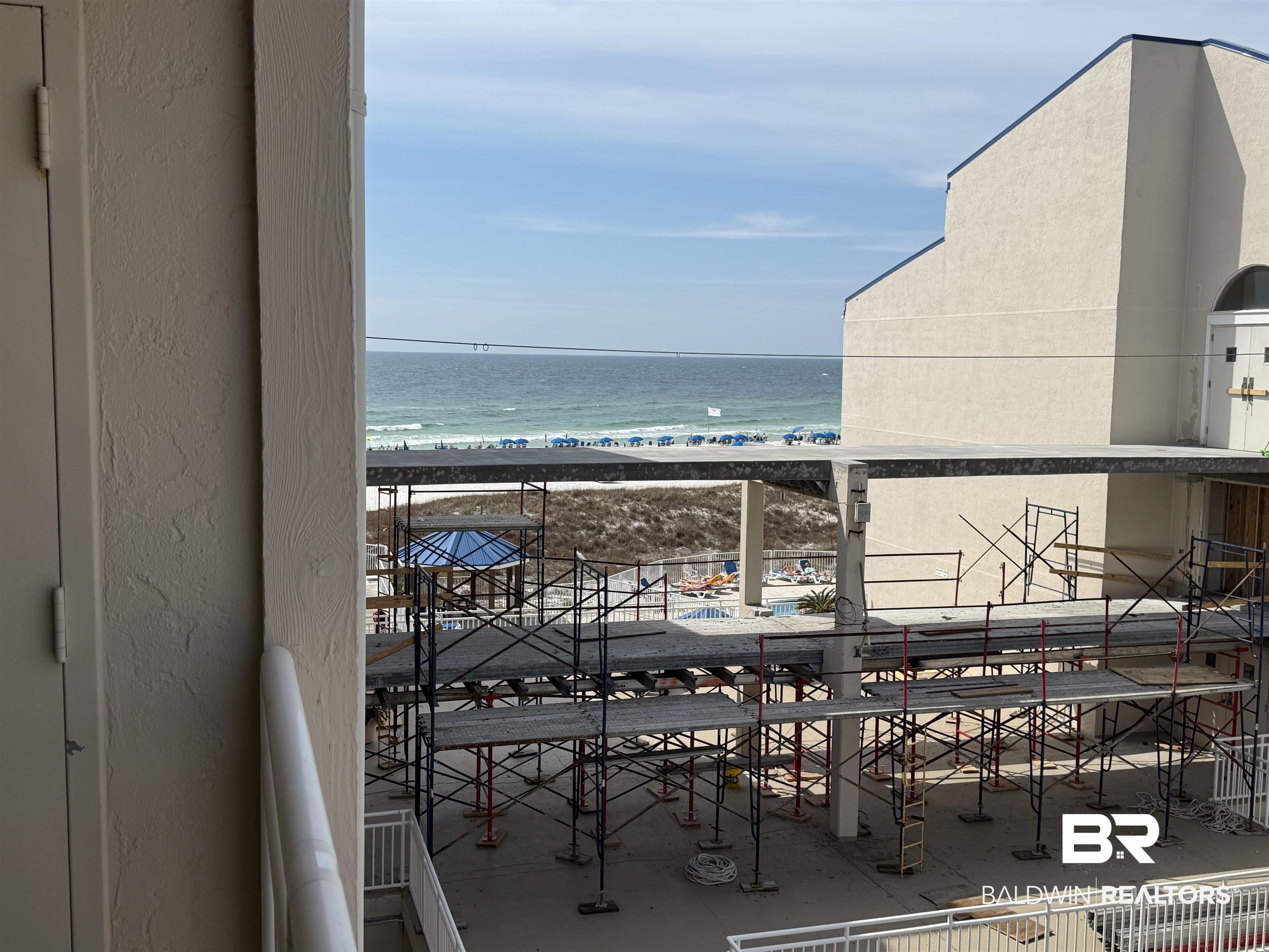 Image 2: Balcony with a view of the beach and a water view