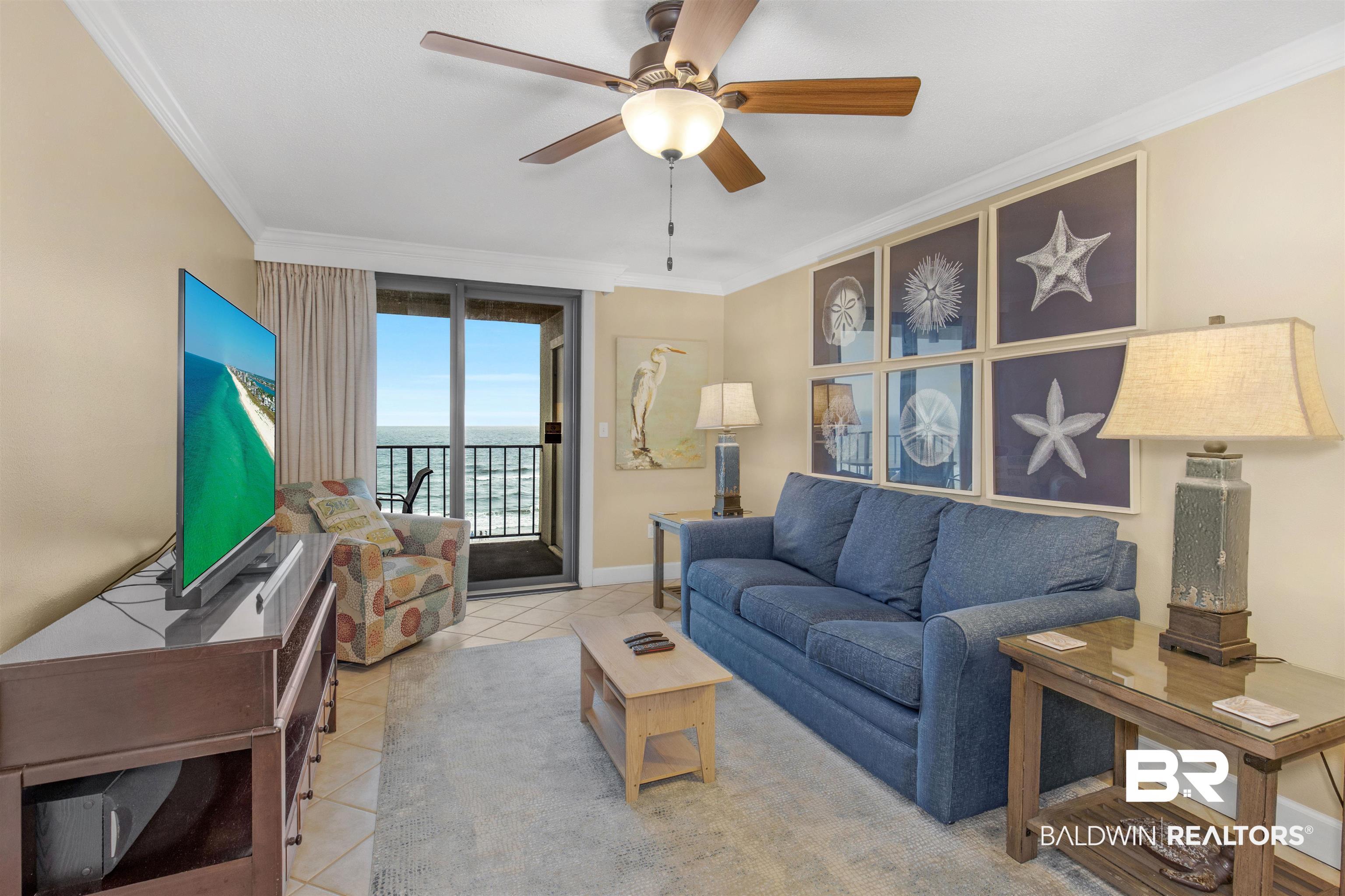 Image 3: Tiled living area featuring baseboards, crown molding, and ceiling fan