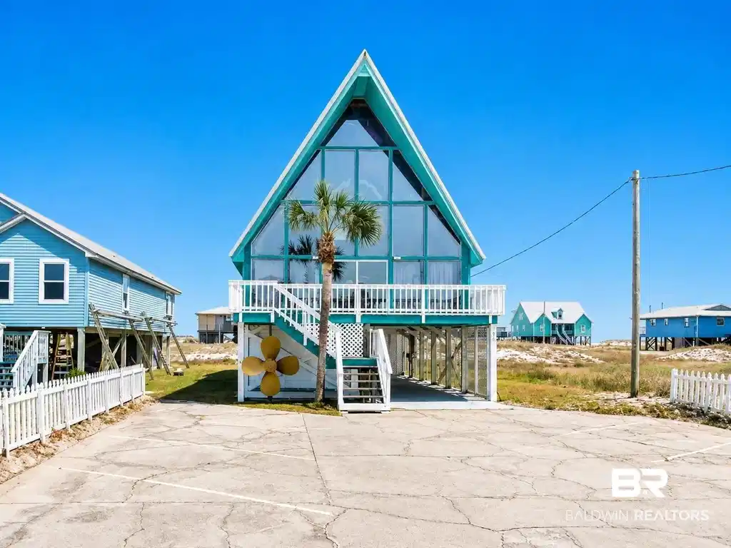 Image 1: Back of property with a wooden deck and stairs