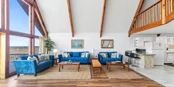 Image 4: Living room with lofted ceiling and light wood-type flooring