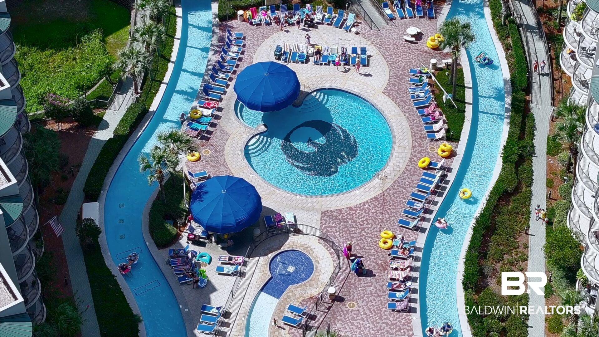 Image 1: Drone / aerial view of a pool area and a community park