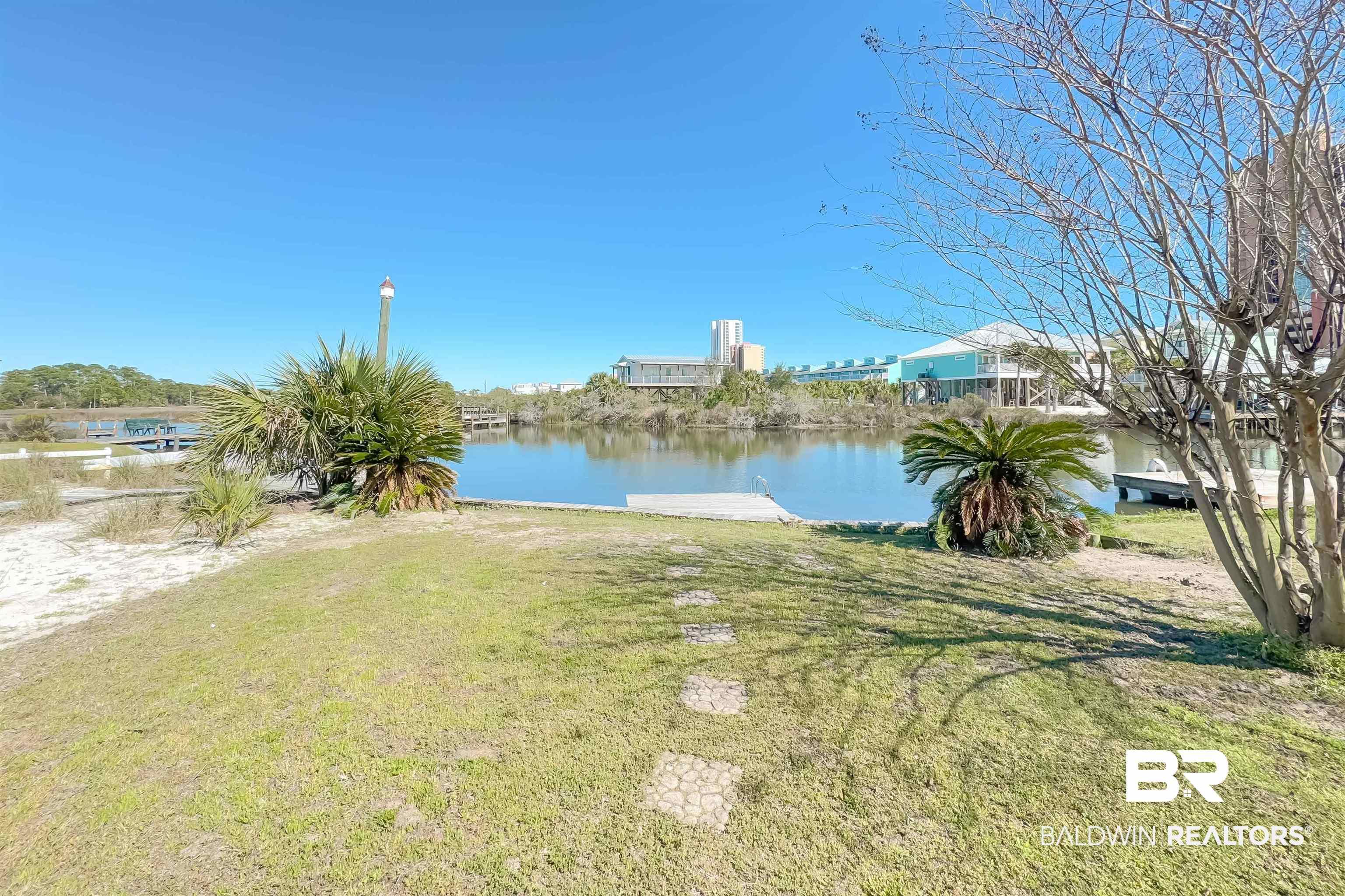 Image 4: View of green lawn featuring a water view