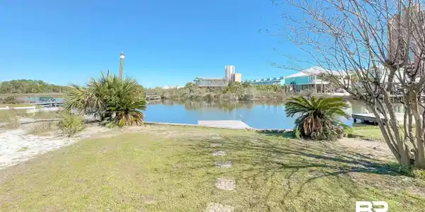 Image 4: View of green lawn featuring a water view