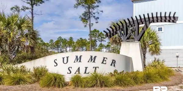 Image 2: Entry monument featuring sculpted lettering, an architectural pergola, and surrounding landscaping