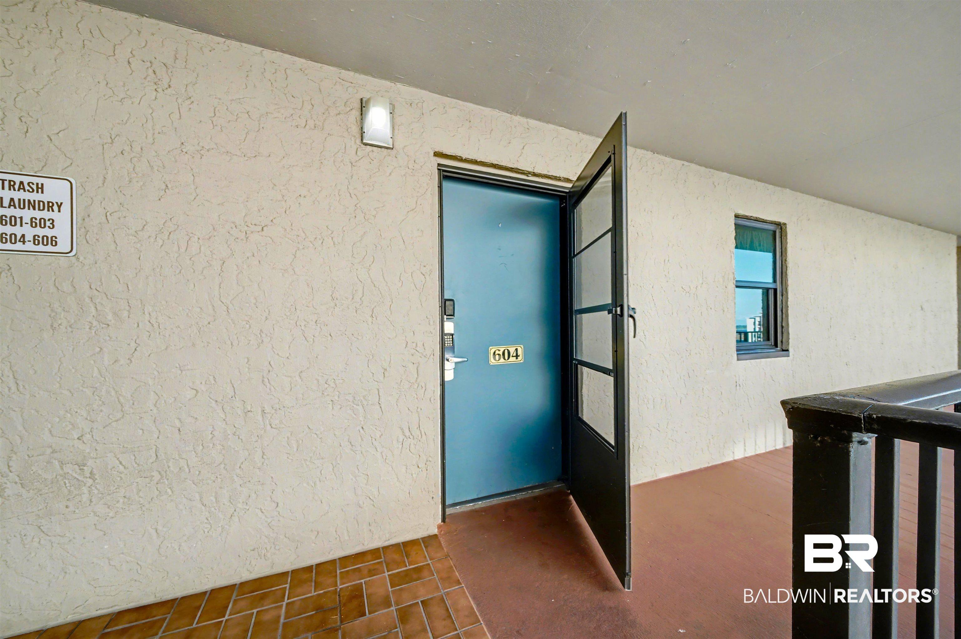 Image 3: Doorway to property with stucco siding