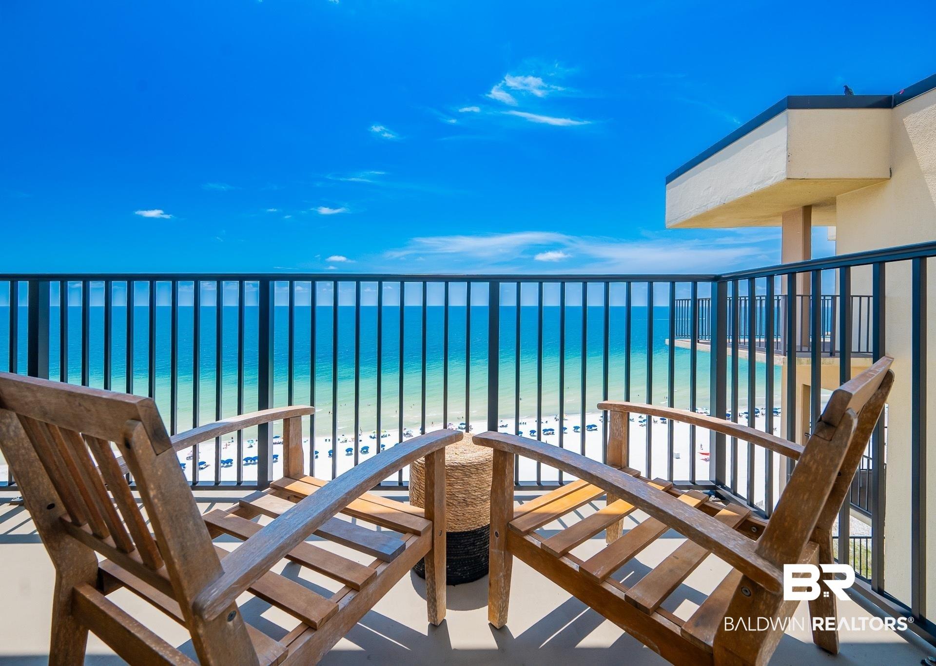 Image 3: Private balcony with a metal railing, concrete flooring, and direct oceanfront exposure