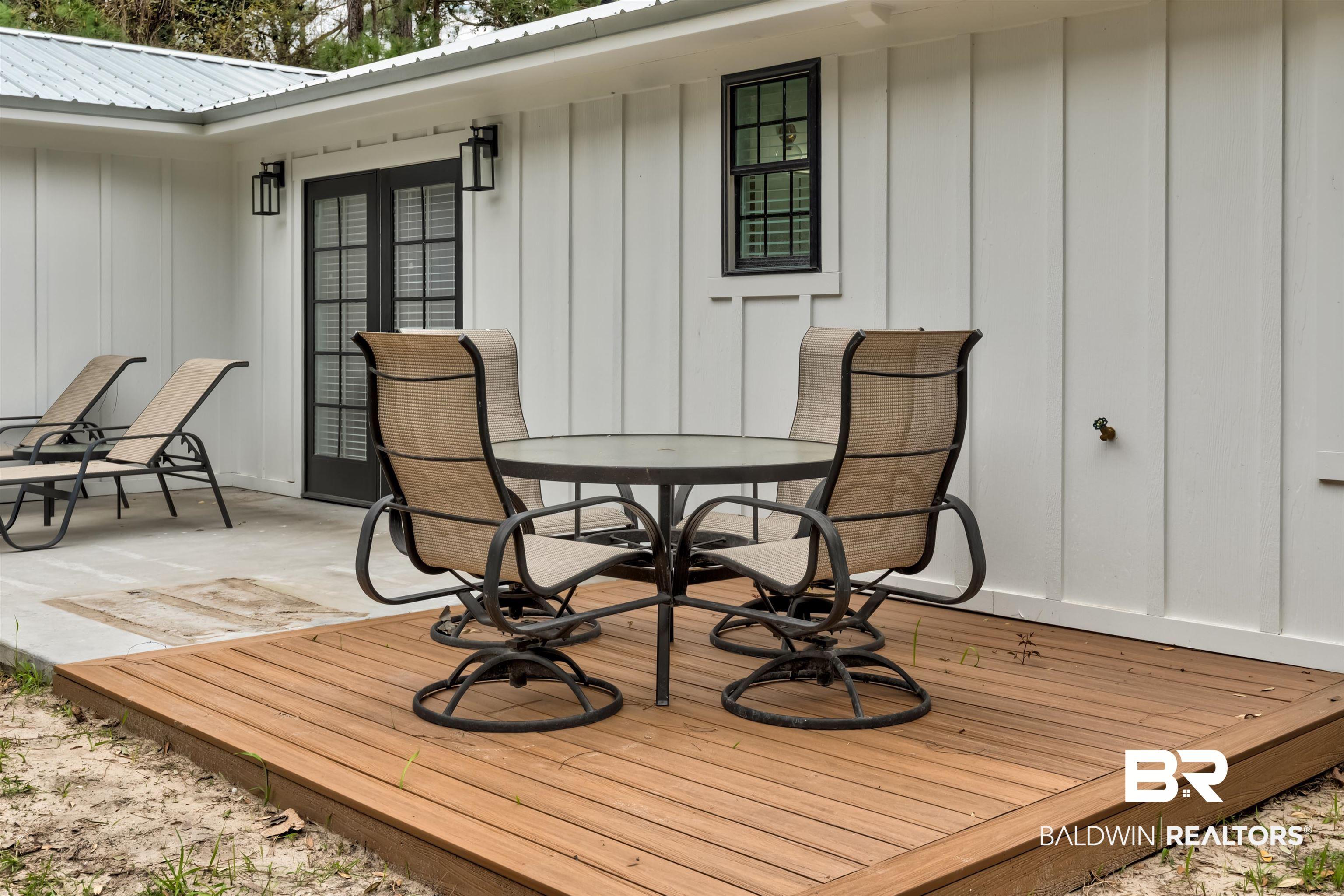Image 3: Wooden terrace featuring outdoor dining space