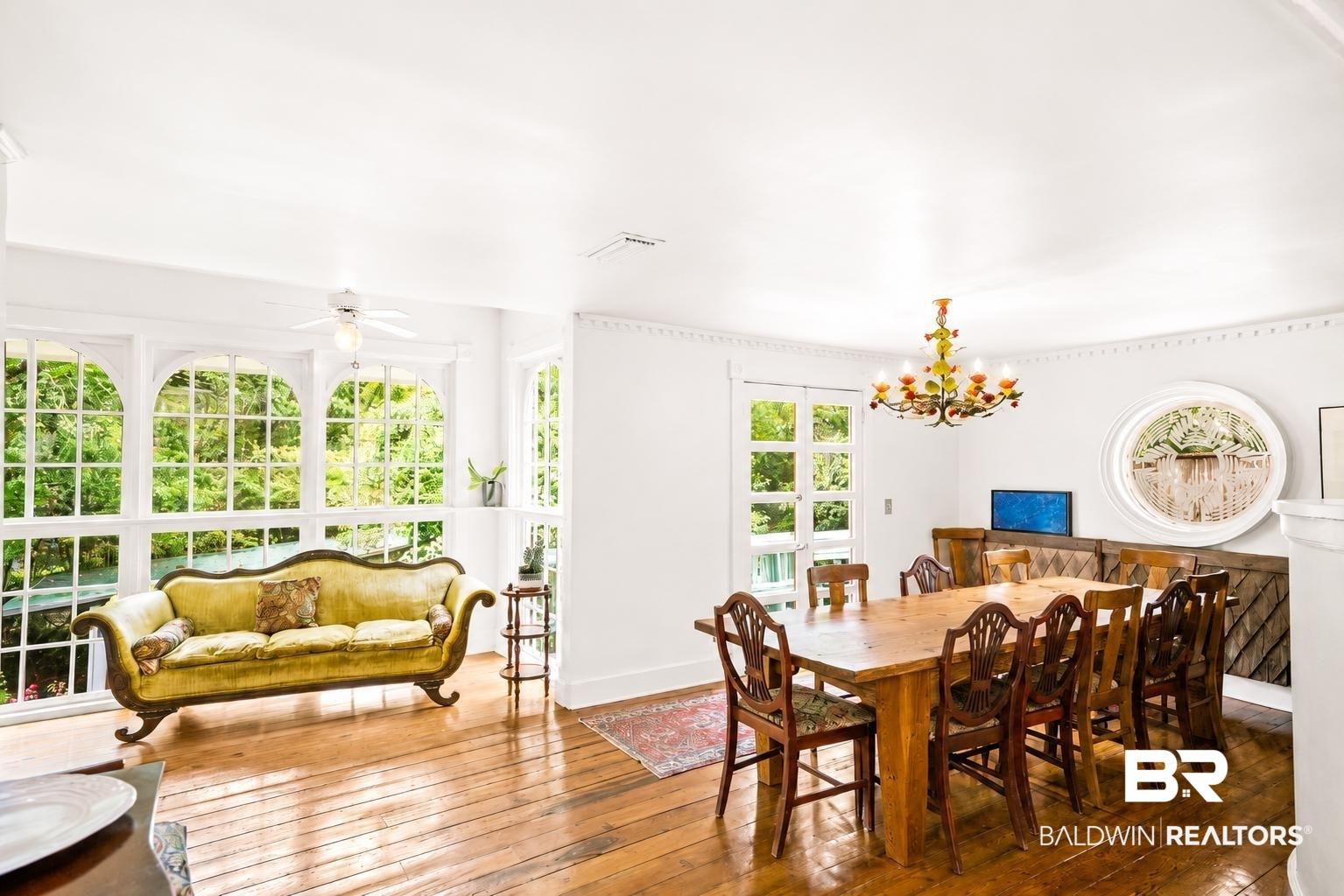 Image 4: Spacious interior featuring wood-finish flooring and extensive natural light