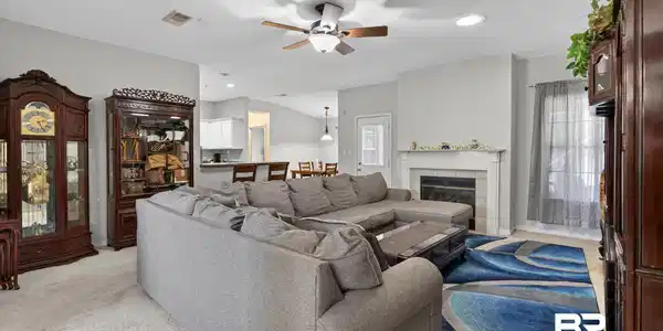 Image 4: Living space featuring light-colored carpeting, a ceiling fan with light, and recessed lighting
