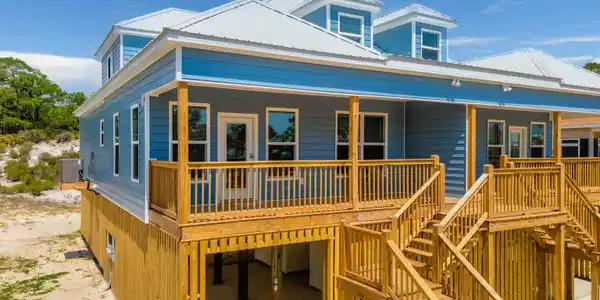 Image 2: View of front of home featuring a metal roof, covered porch, and stairs