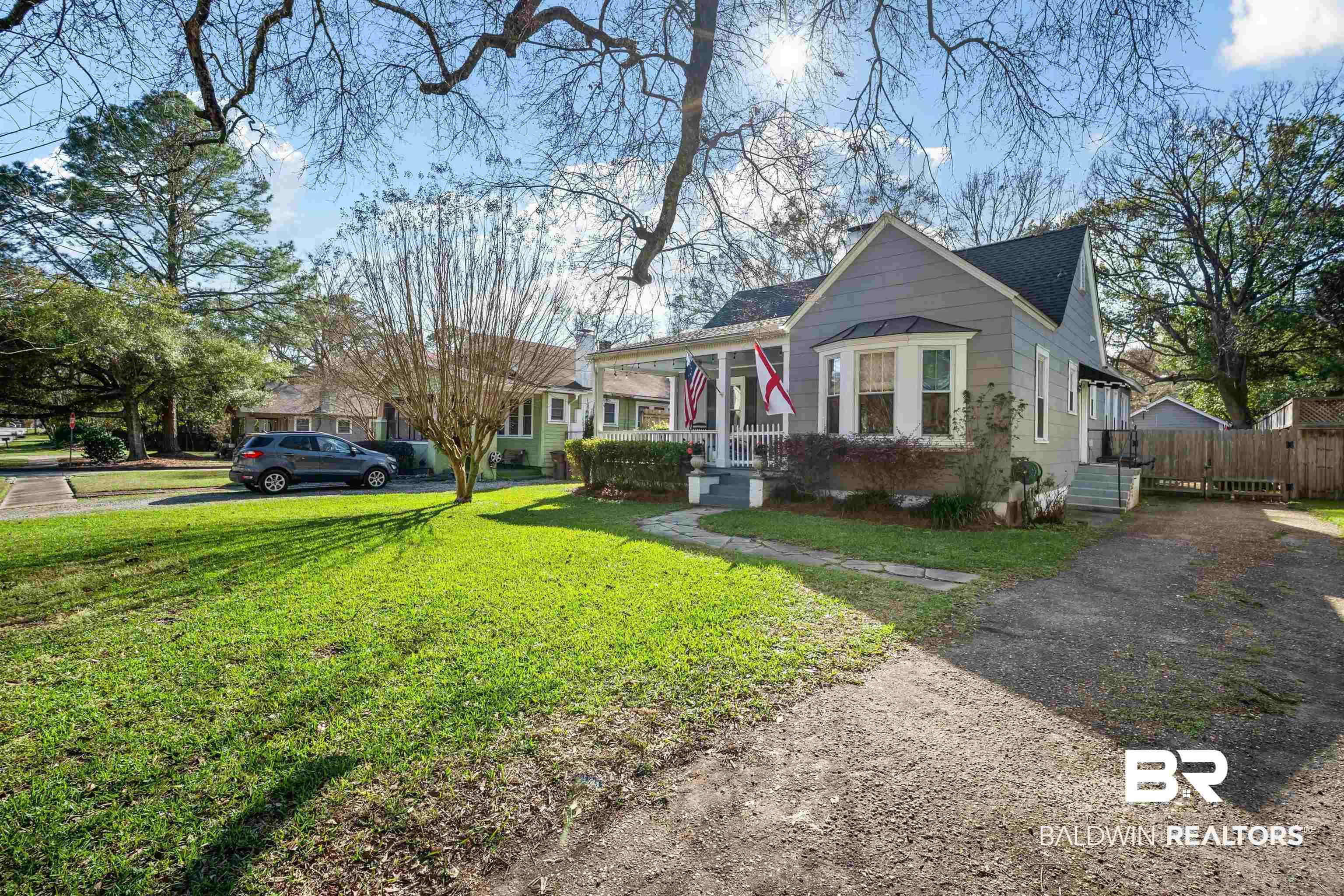 Image 3: View of front of property with a porch and a front yard