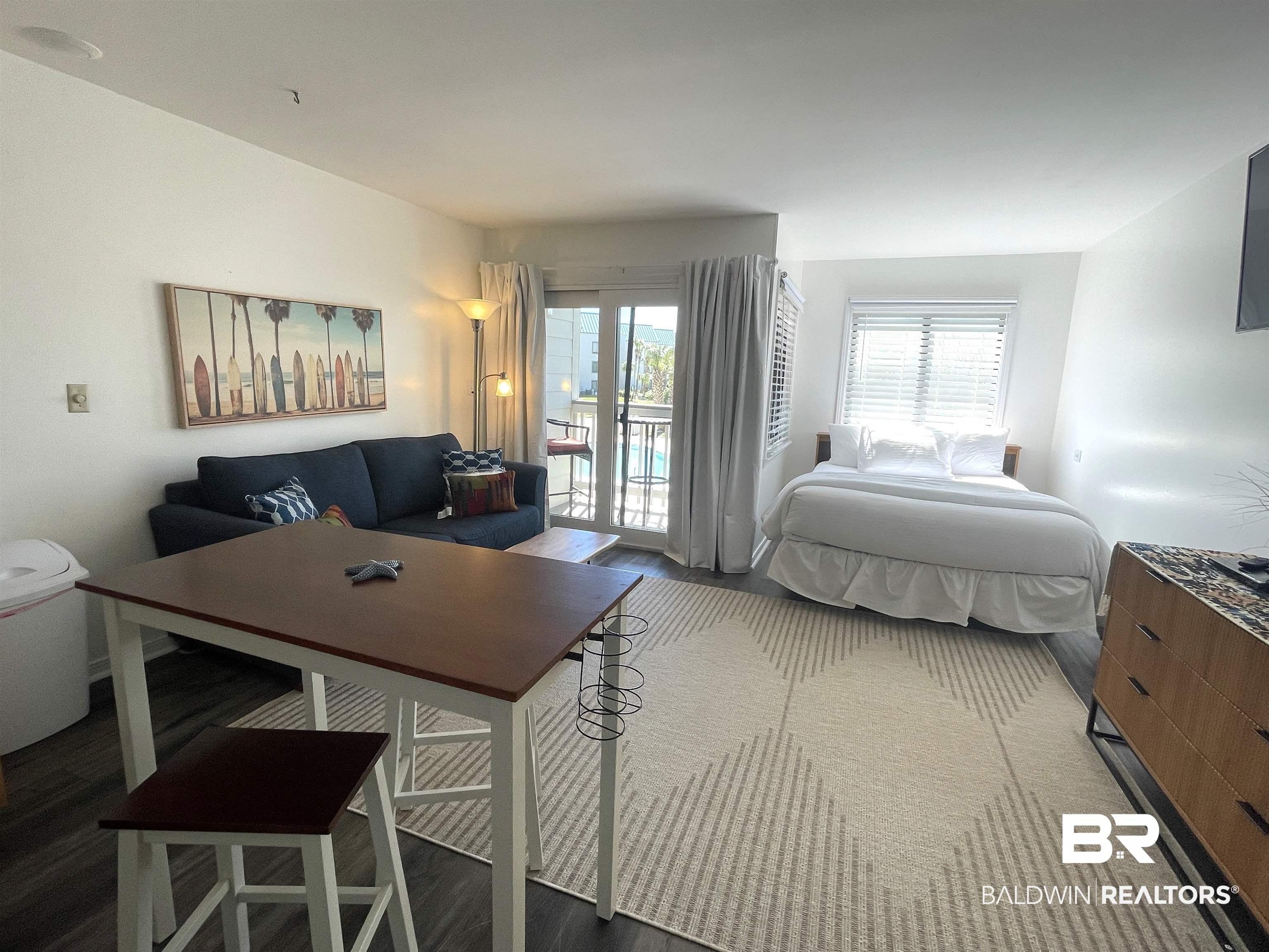 Image 4: Bedroom featuring access to outside and wood finished floors