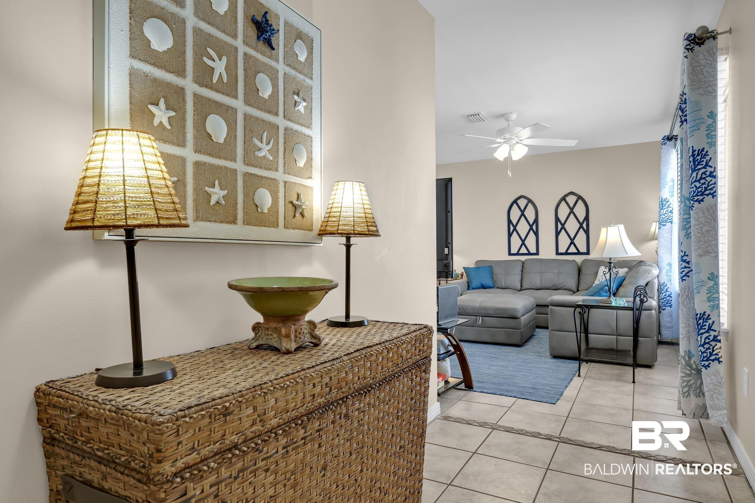 Image 3: Neutral-toned walls complement the tile flooring with a decorative border