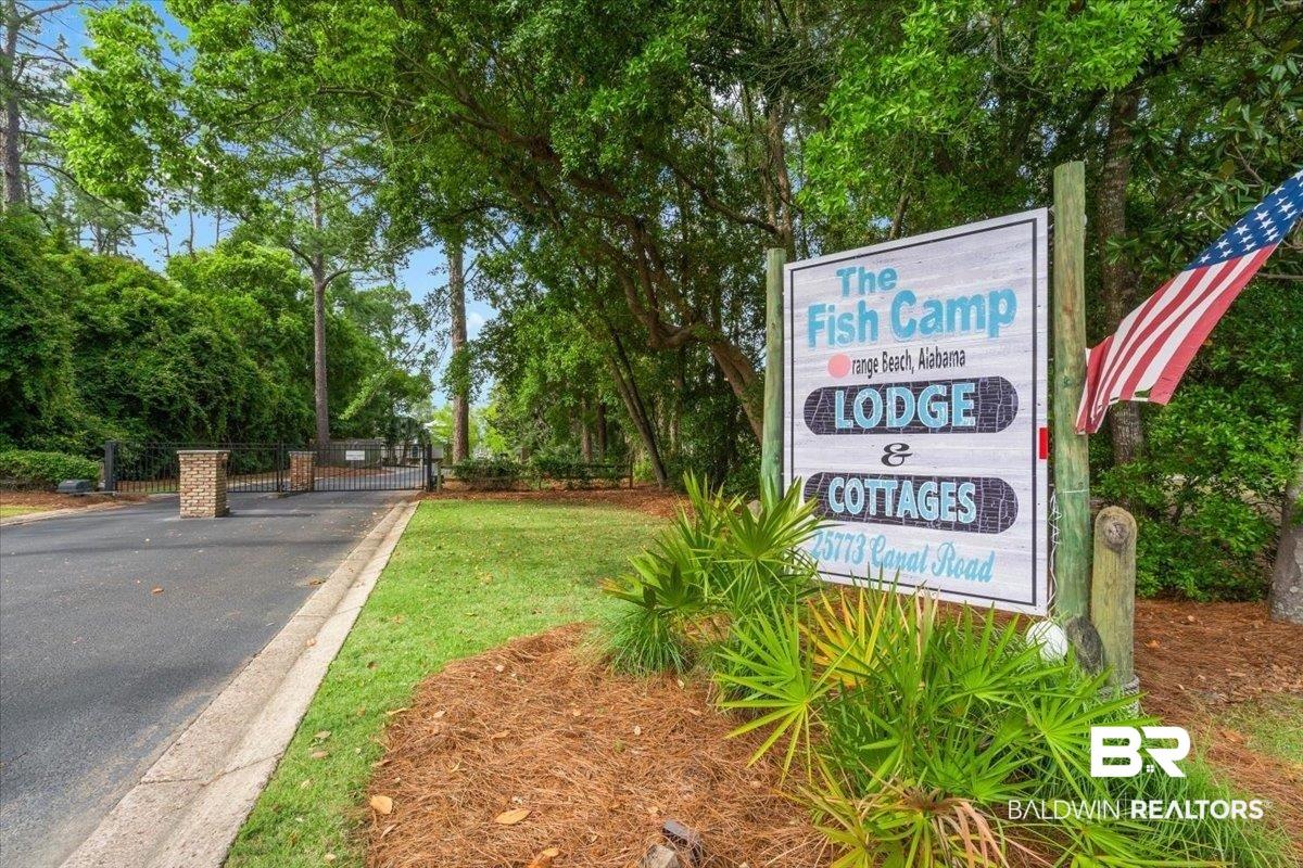 Image 2: Entry sign for "The Fish Camp Lodge & Cottages" featuring a visible address