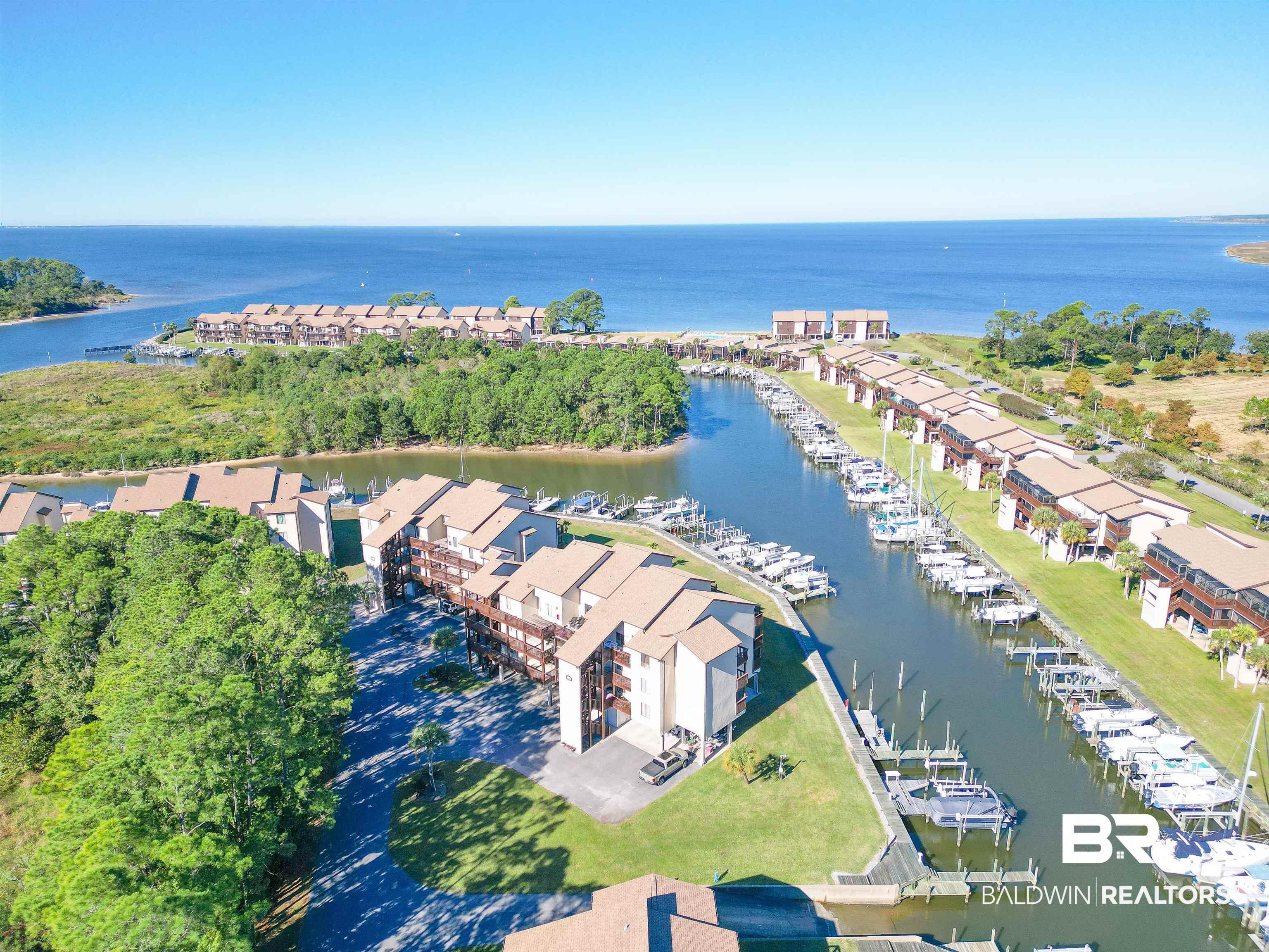 Image 2: Coastal community featuring waterfront residences and a private marina with multiple boat slips