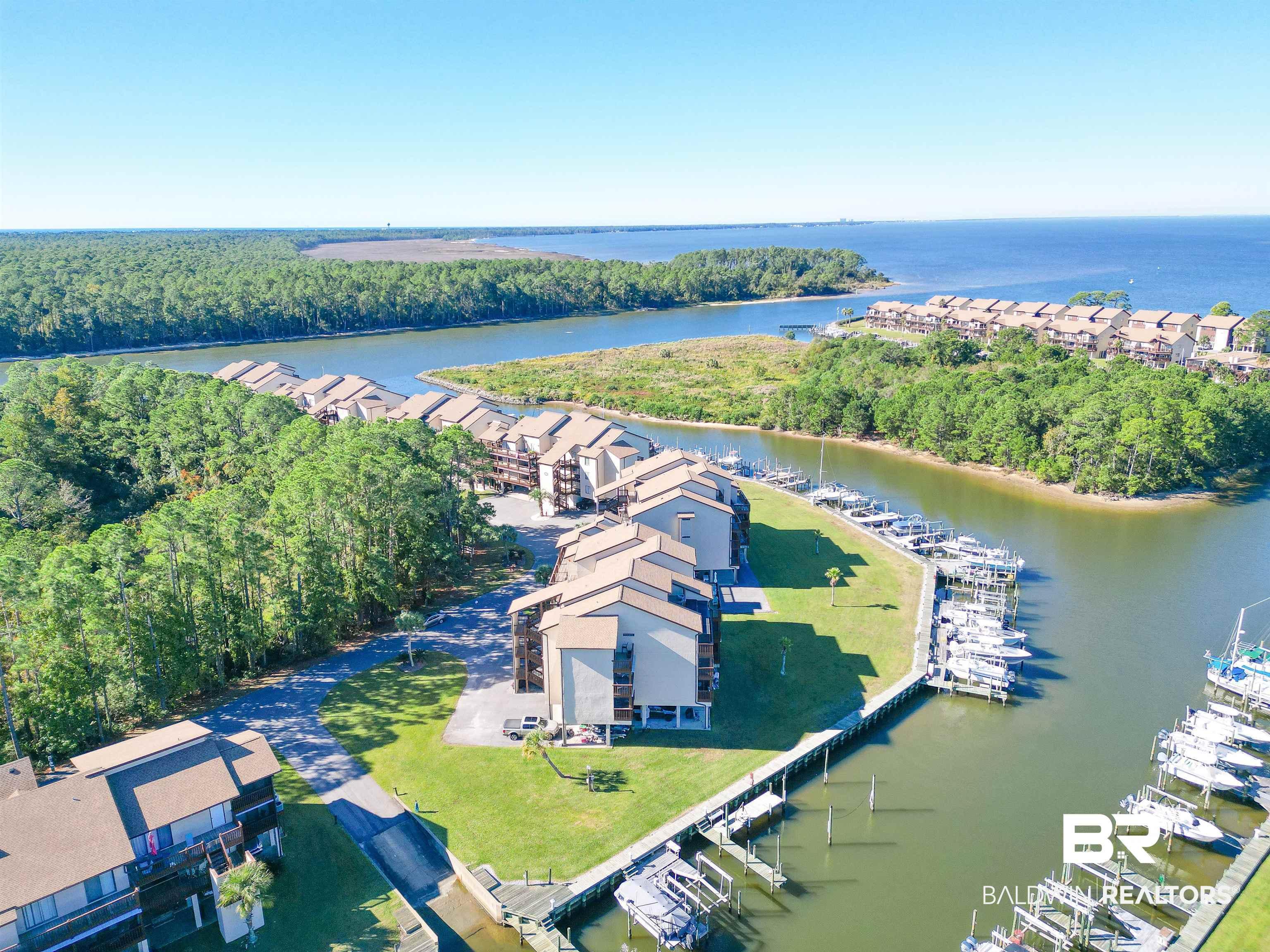 Image 3: Waterfront community featuring multiple multi-story residential buildings with private balconies, surrounded by mature trees