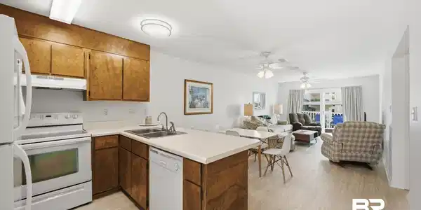 Image 2: Open-concept living area with wood-finish flooring