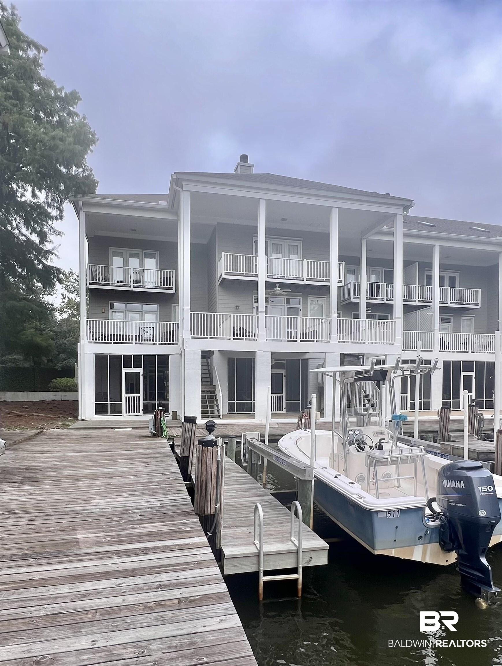 Image 2: View of dock featuring a water view and a balcony