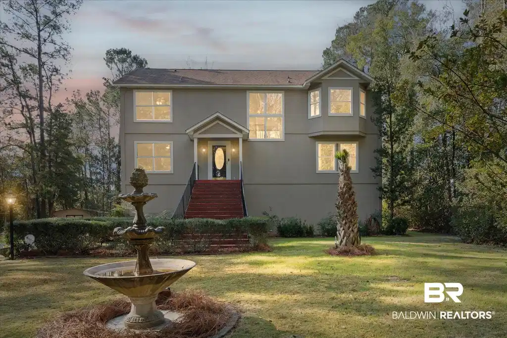 Image 1: Traditional-style house featuring a front yard and stucco siding