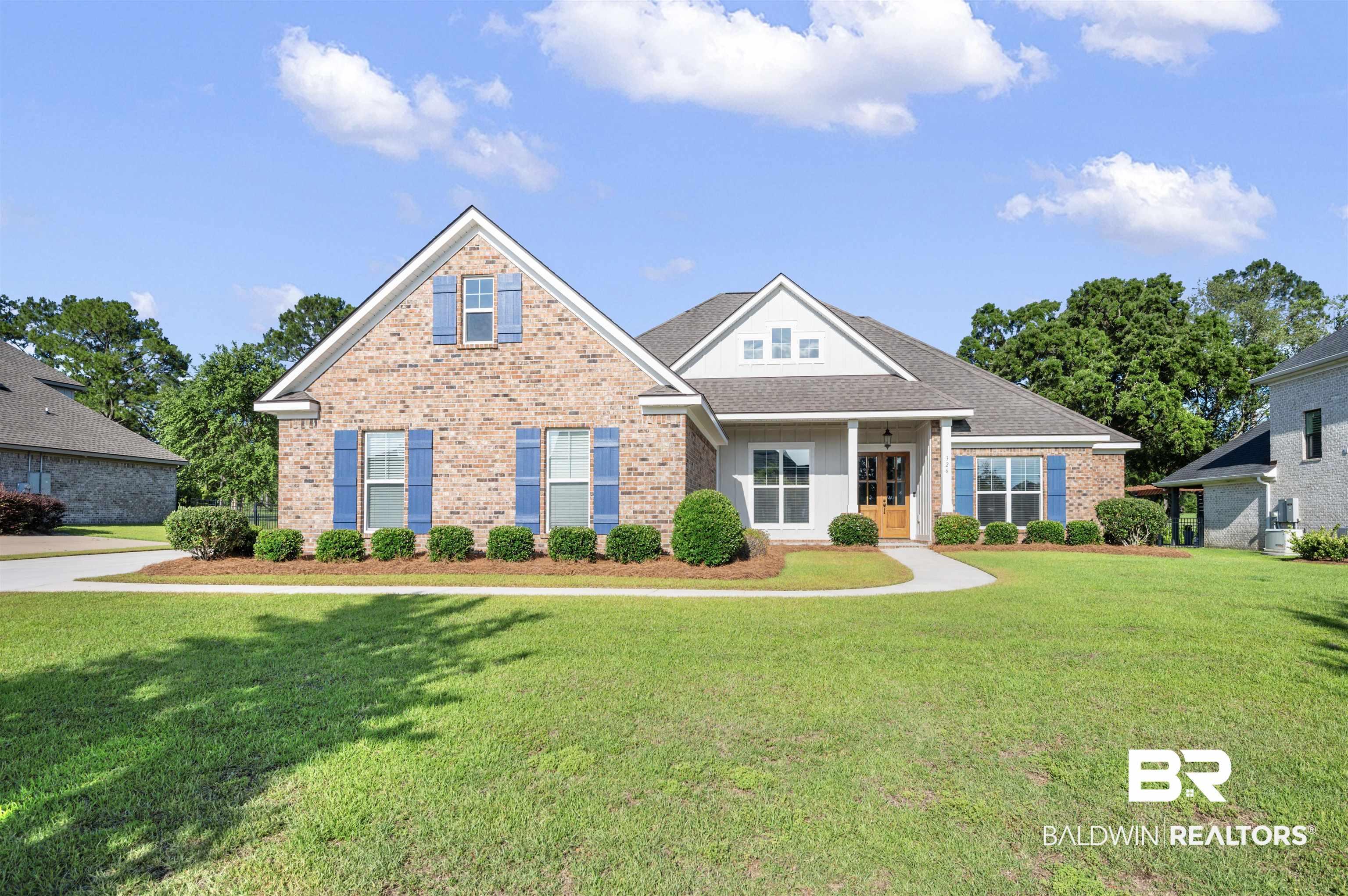 Image 1: Brick and siding exterior featuring a covered entry, gabled rooflines, a front yard with established landscaping, and a concrete walkway