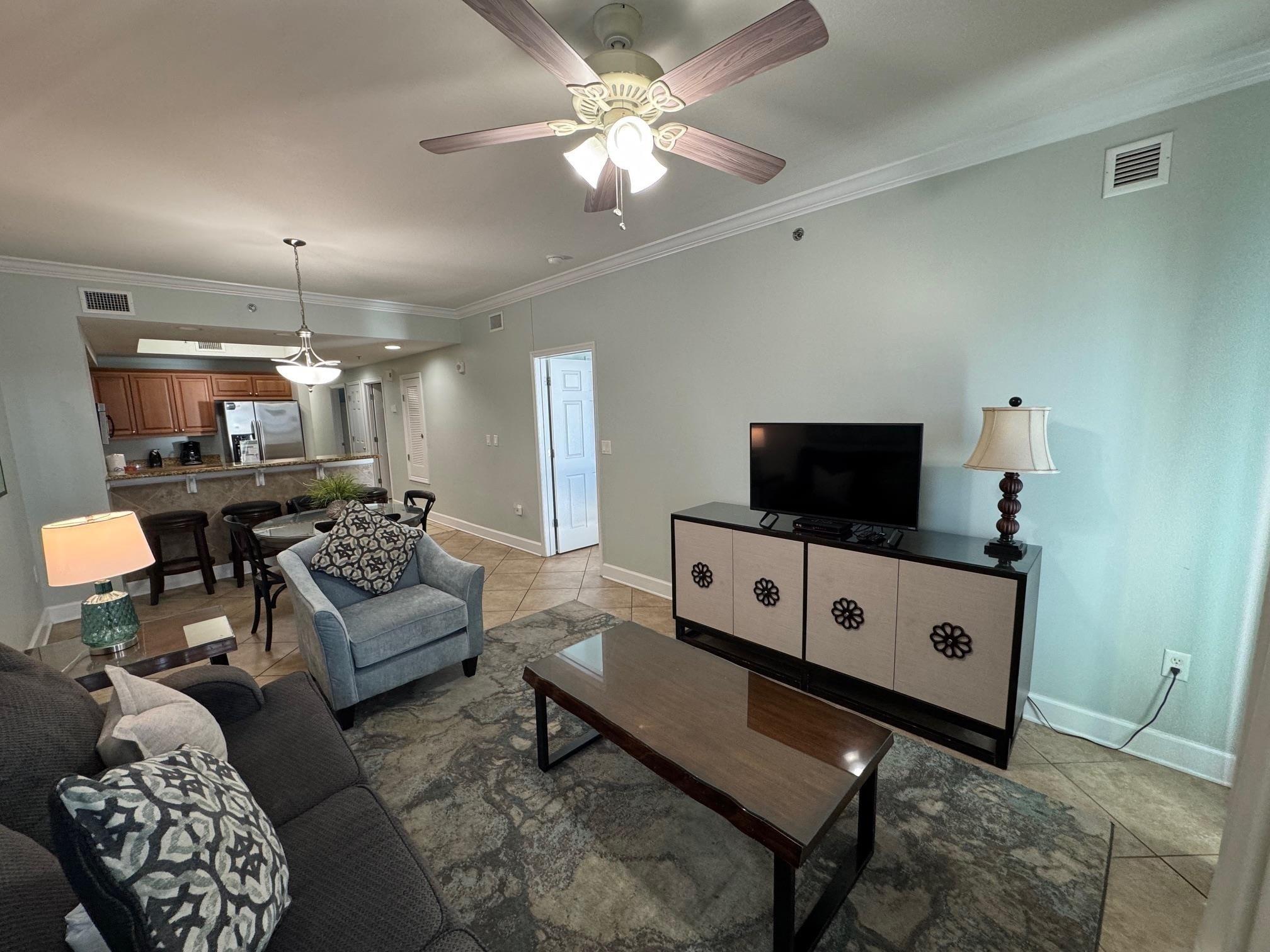 Image 3: Tiled living room featuring crown molding and ceiling fan