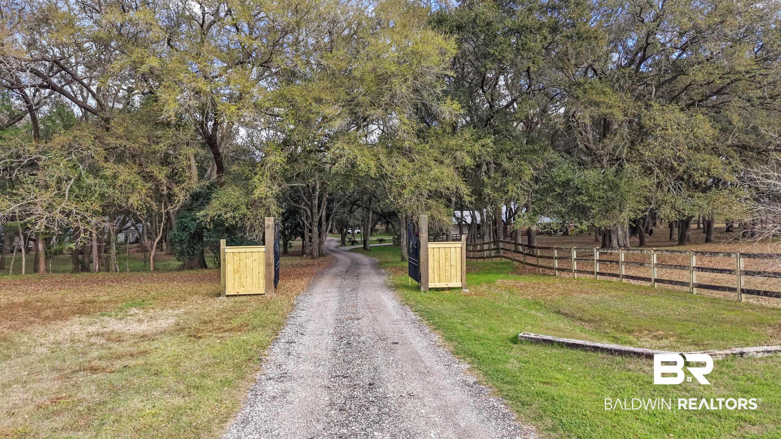 Image 2: View of dirt / gravel road with view of wooded area