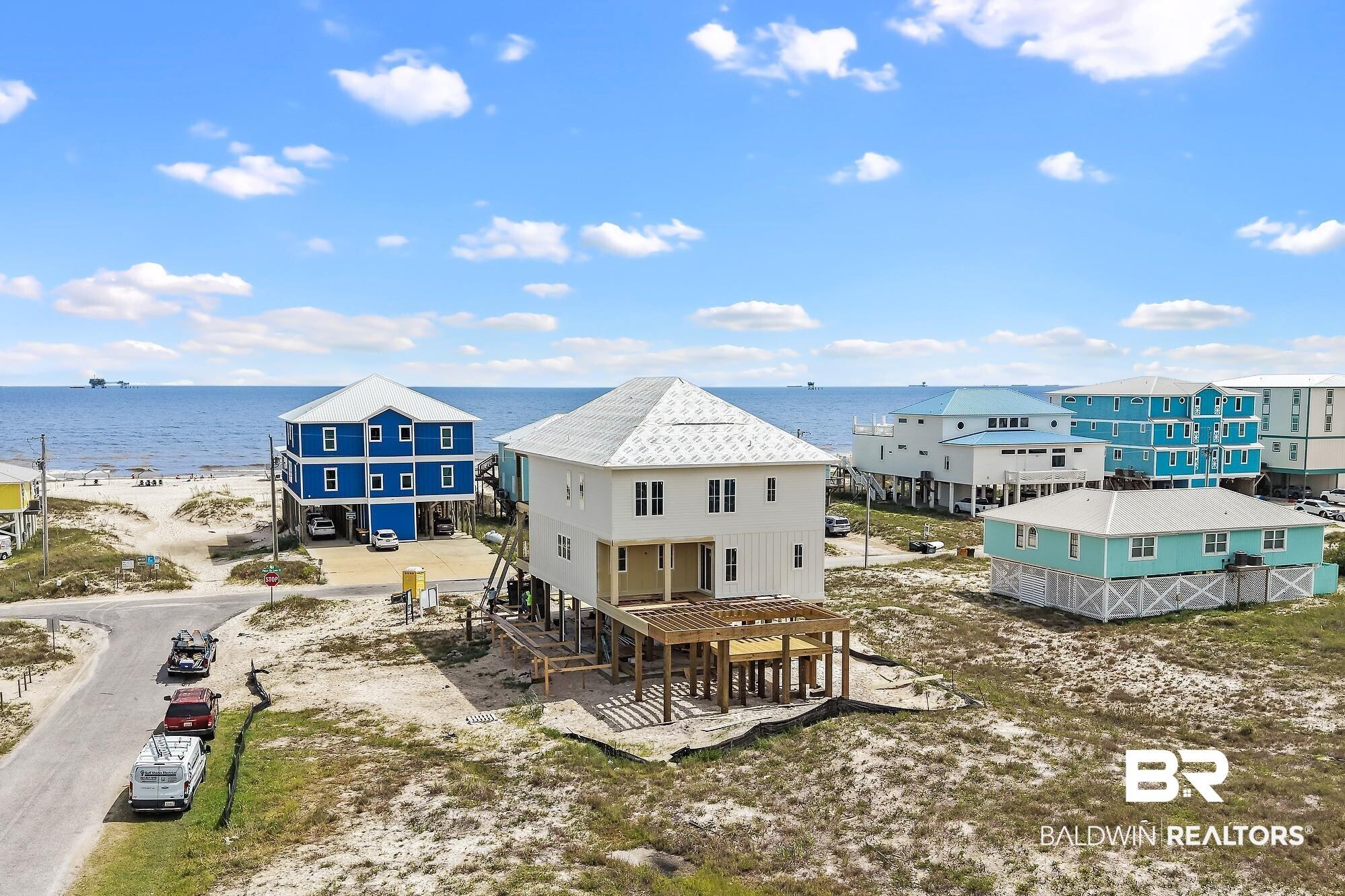 Image 2: Coastal-style residence featuring white siding and a multi-level design