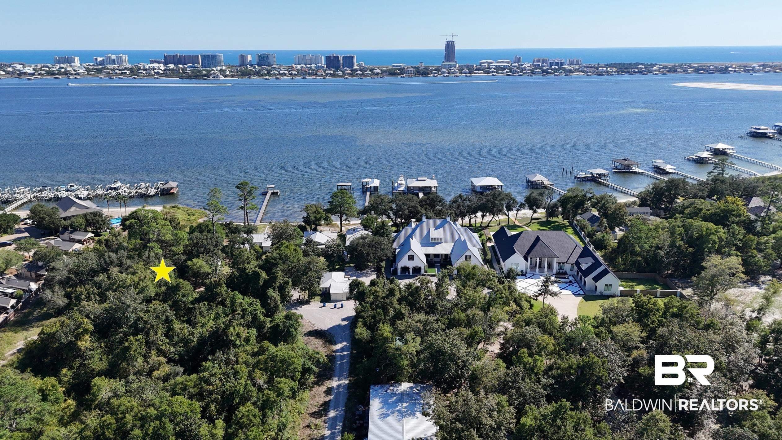 Image 1: Aerial overview of property's location featuring a nearby body of water
