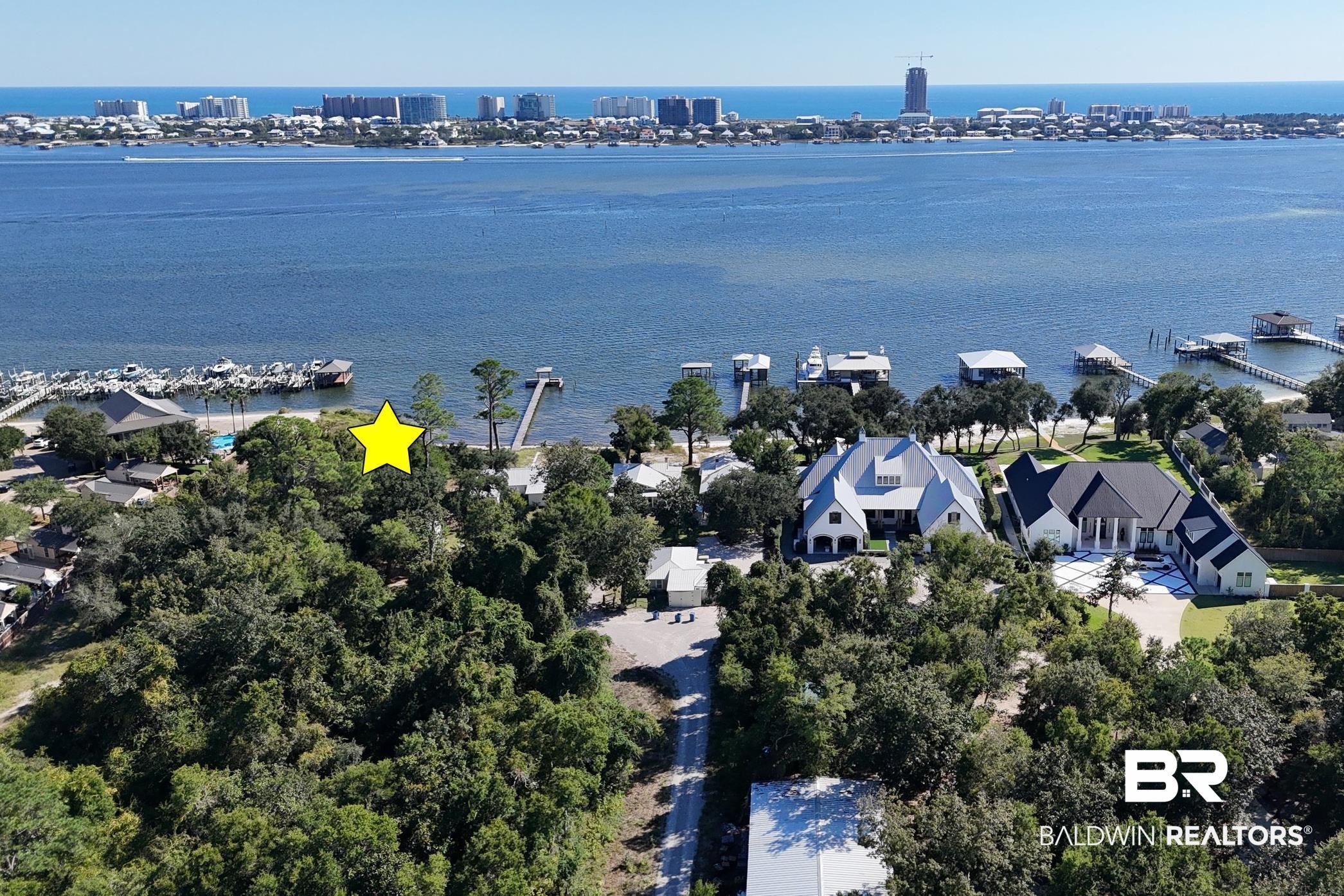 Image 3: Aerial perspective of suburban area featuring a large body of water