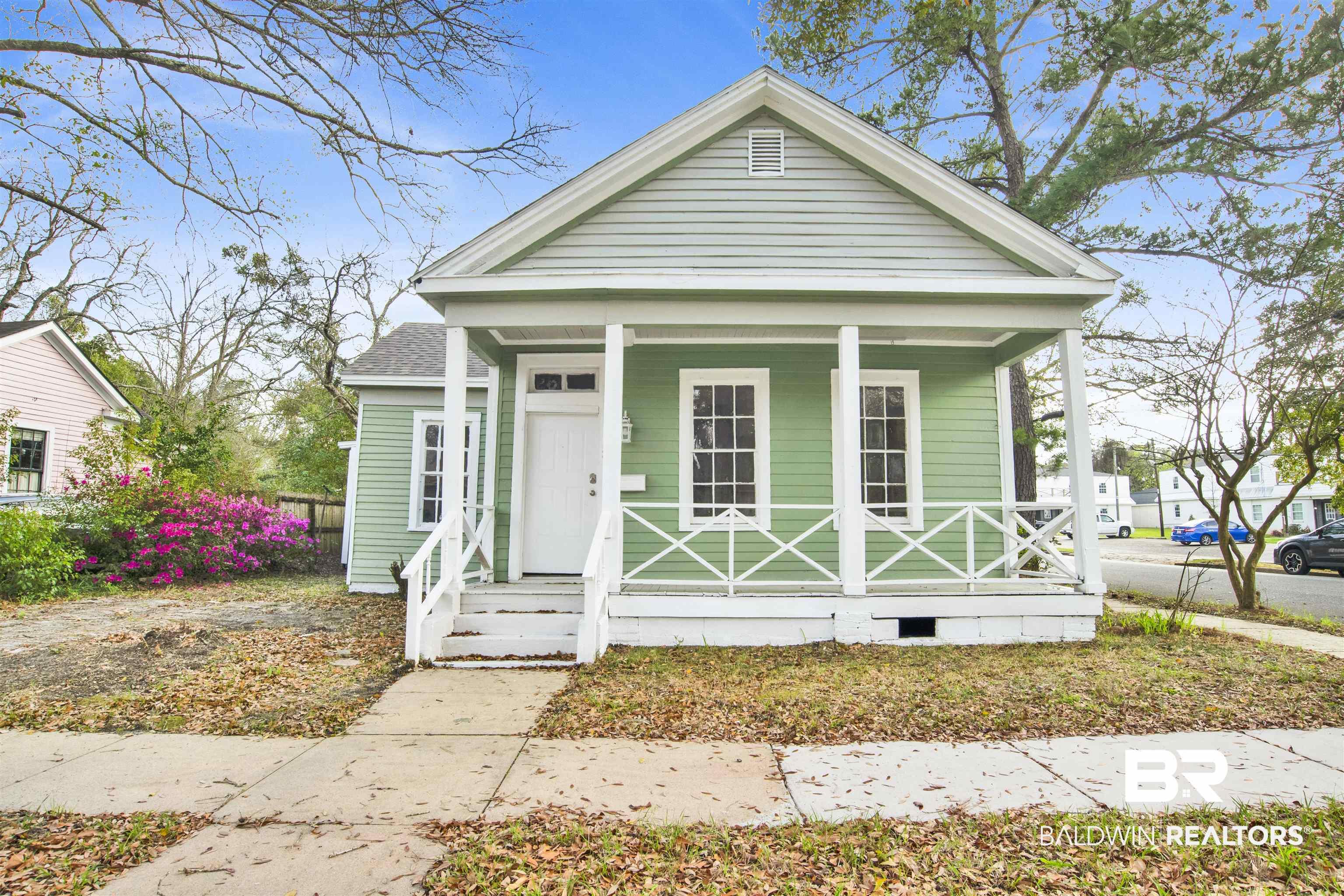 Image 1: View of front of home featuring a porch and crawl space