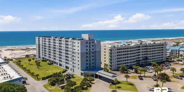 Image 3: Aerial view of apartment complex and expansive beach