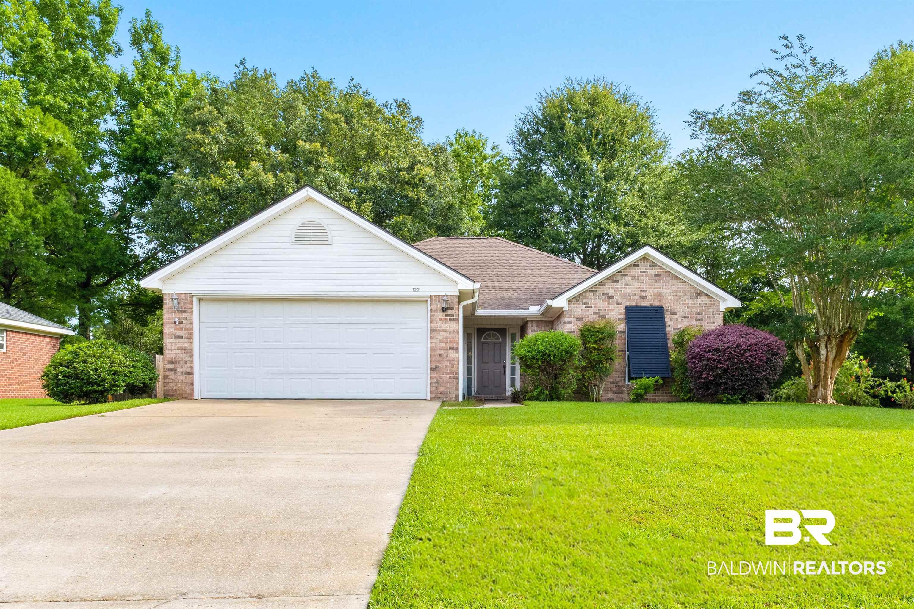 Image 1: Brick and siding exterior featuring an attached two-car garage