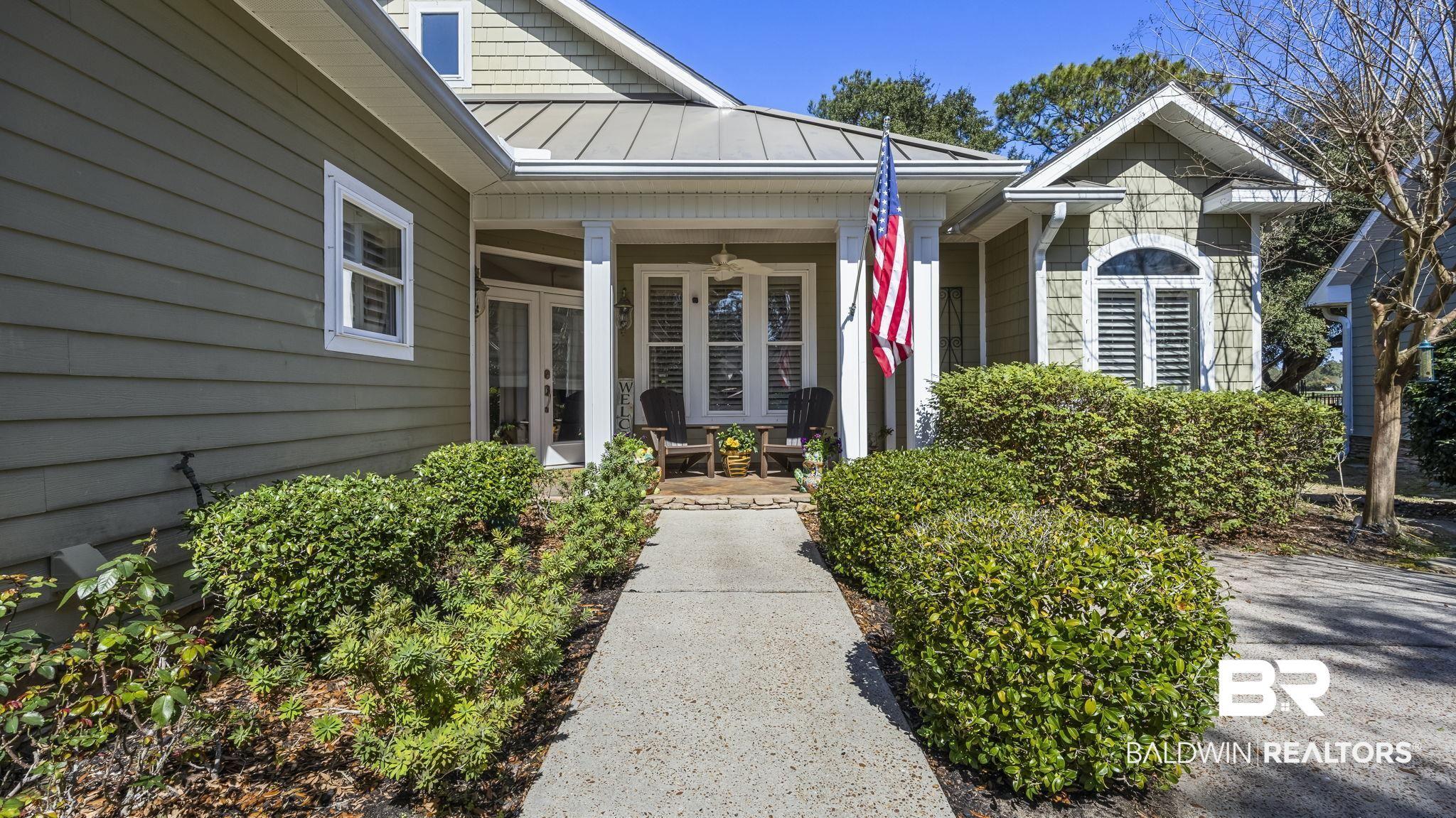 Image 4: Entrance to property featuring a standing seam roof, covered porch, and french doors
