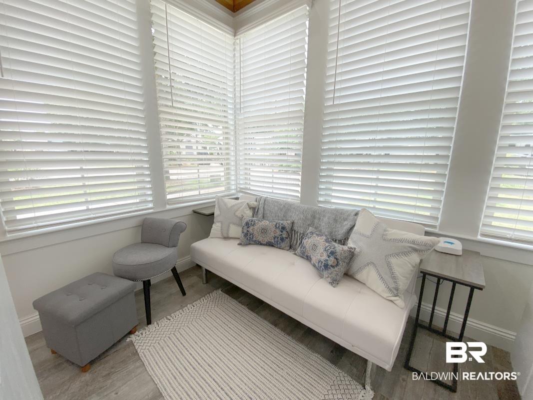 Image 2: Sunroom with extensive window coverage and white horizontal blinds