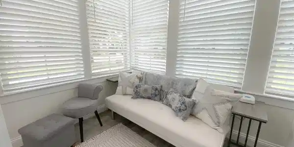 Image 2: Sunroom with extensive window coverage and white horizontal blinds
