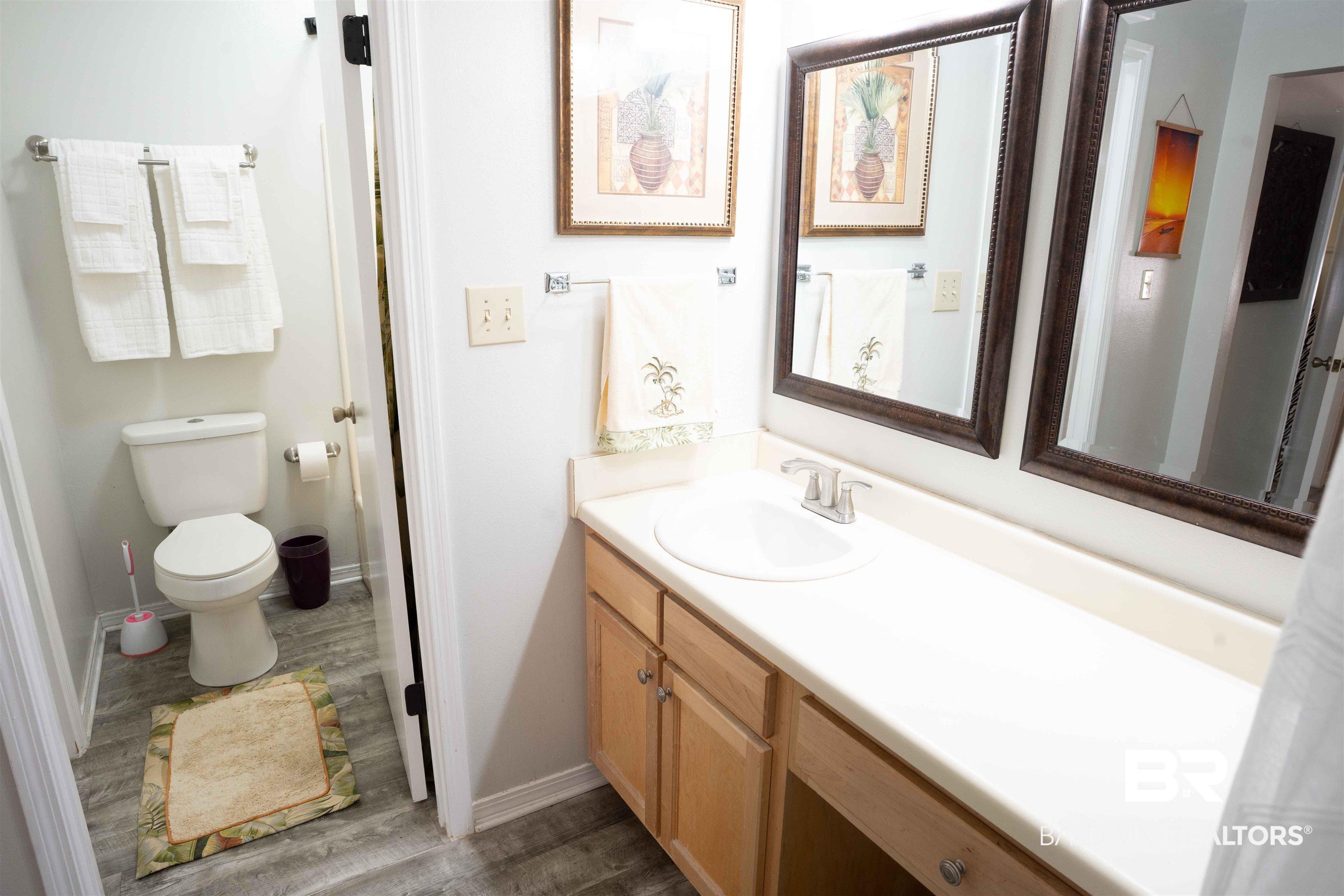 Image 4: Bathroom featuring vanity and dark wood-type flooring