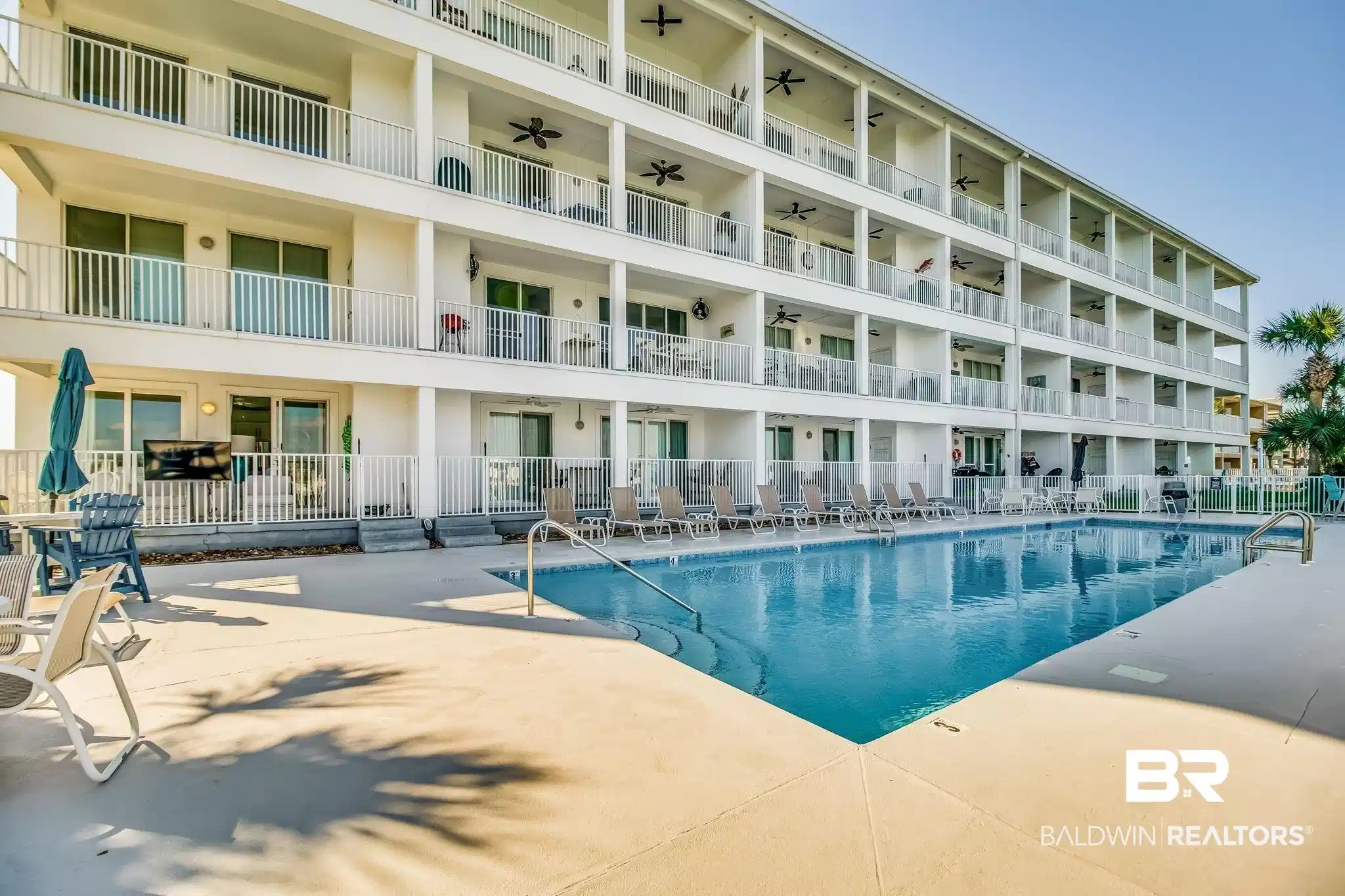 Image 1: Community pool featuring a patio area