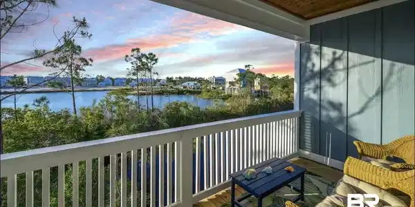 Image 2: Covered balcony with natural wood ceiling, recessed lighting, white balustrade, and wood-finish flooring