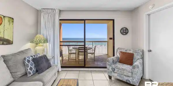 Image 4: Tiled living room with a water view and a textured ceiling