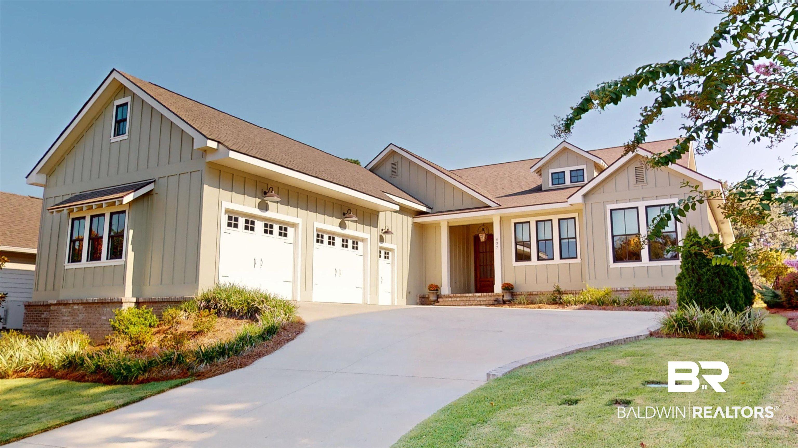 Image 2: Modern inspired farmhouse featuring a shingled roof, board and batten siding, and driveway